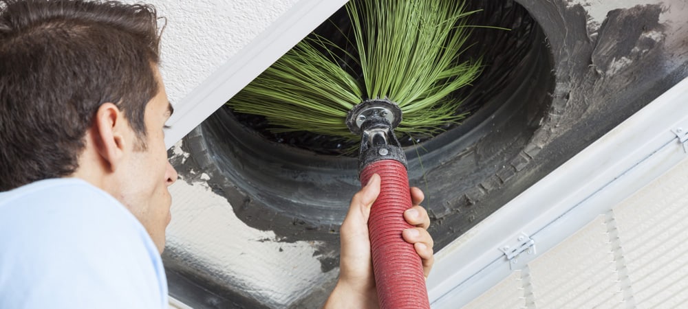 technician cleaning air conditioning ducts