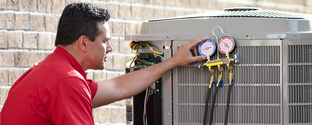 Tech fixing Air Conditioning unit