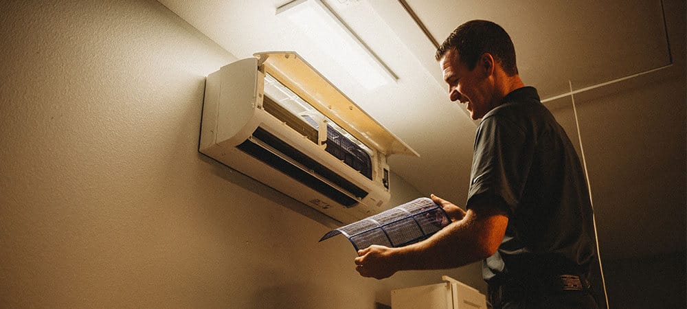 Lunsford Ductless Lunsford Air Conditioning & Heating tech working on a ductless unit